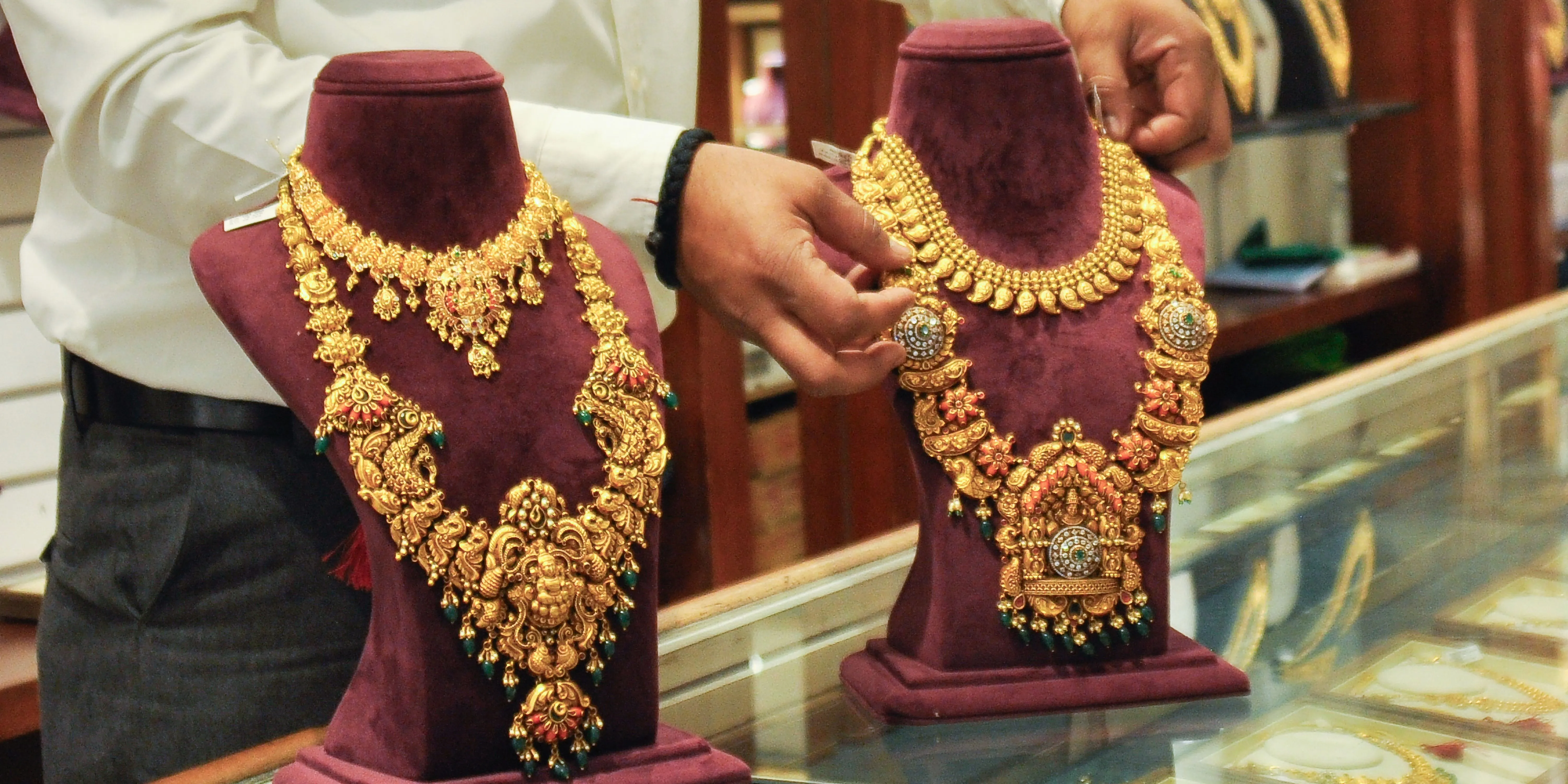 Shopkeeperarrangesgoldornaments